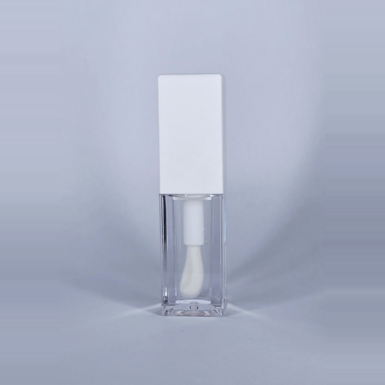 Gloss Angeles clear lip gloss in a clear square bottle with a white cap