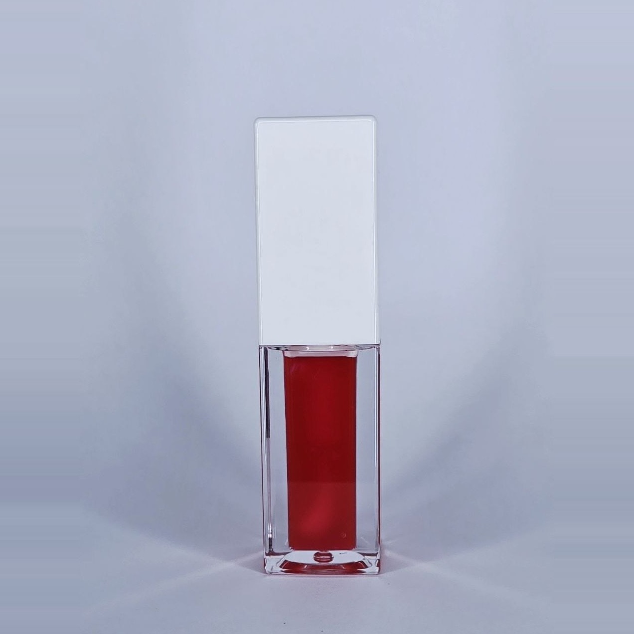 Love red lip gloss in a clear square bottle with a white cap