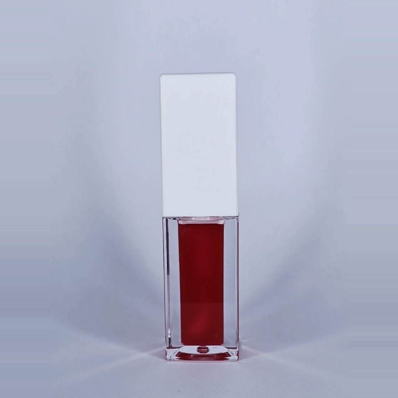 True Love dark red lip gloss in a clear square bottle with a white cap